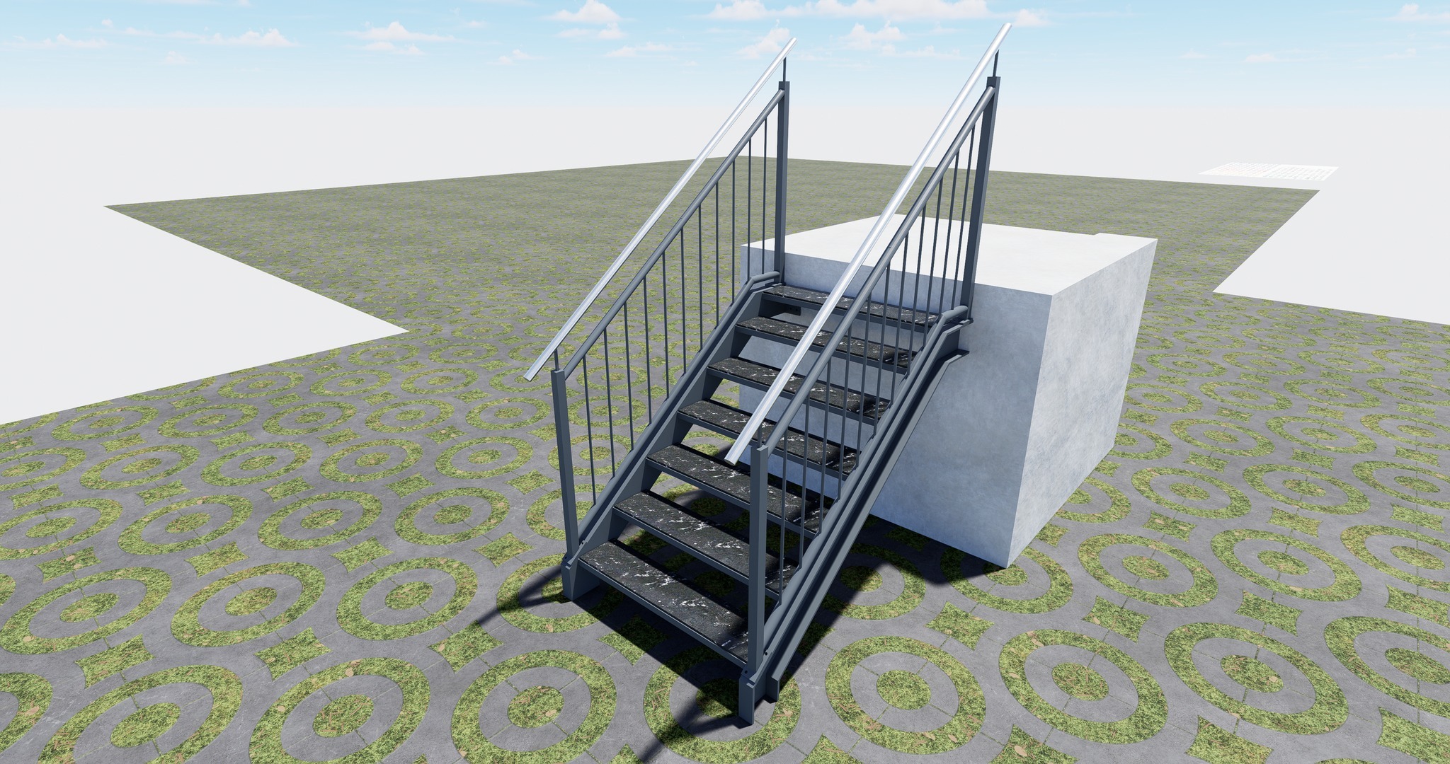 Metalowe schody zewnętrzne z szarymi poręczami i czarnymi stopniami, umieszczone na tle kostki brukowej z wzorem okręgów wypełnionych trawą, przylegające do białego betonowego bloku.