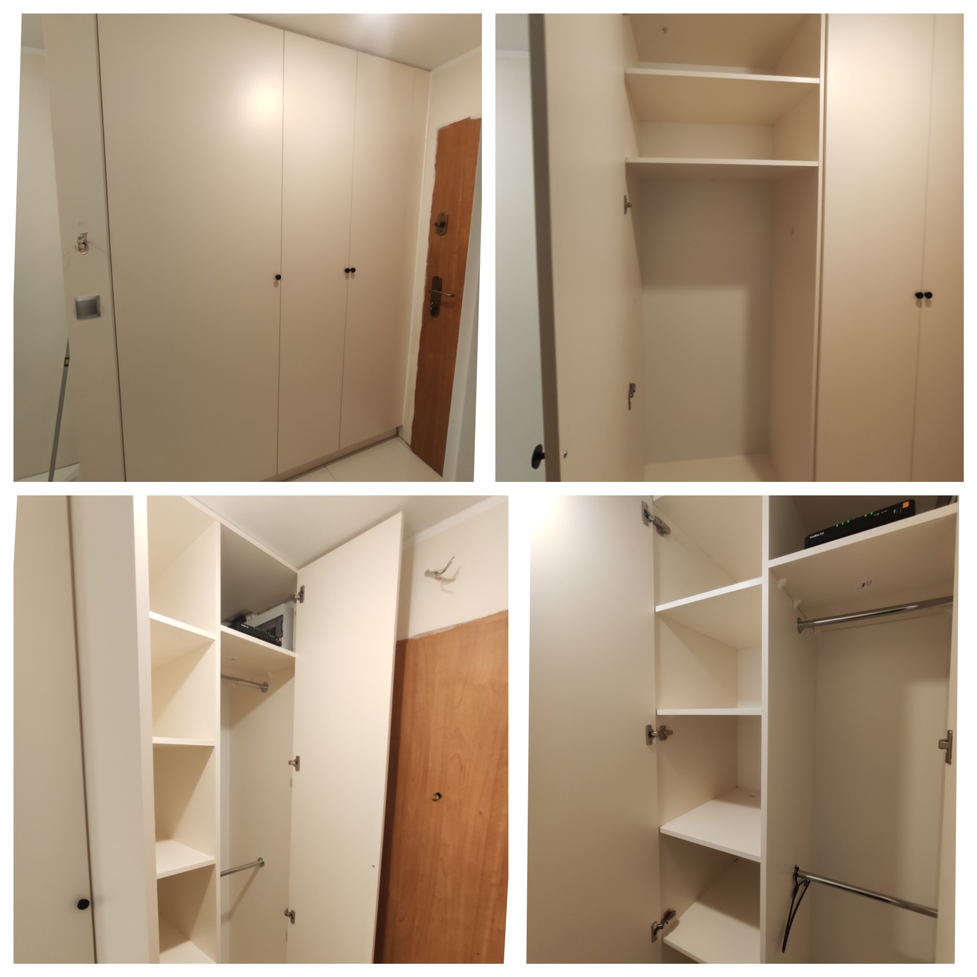 Biała szafa wnękowa z otwartymi drzwiami, widoczne półki i drążki na ubrania, obok drewniane drzwi wejściowe, na jednej z półek leży router.