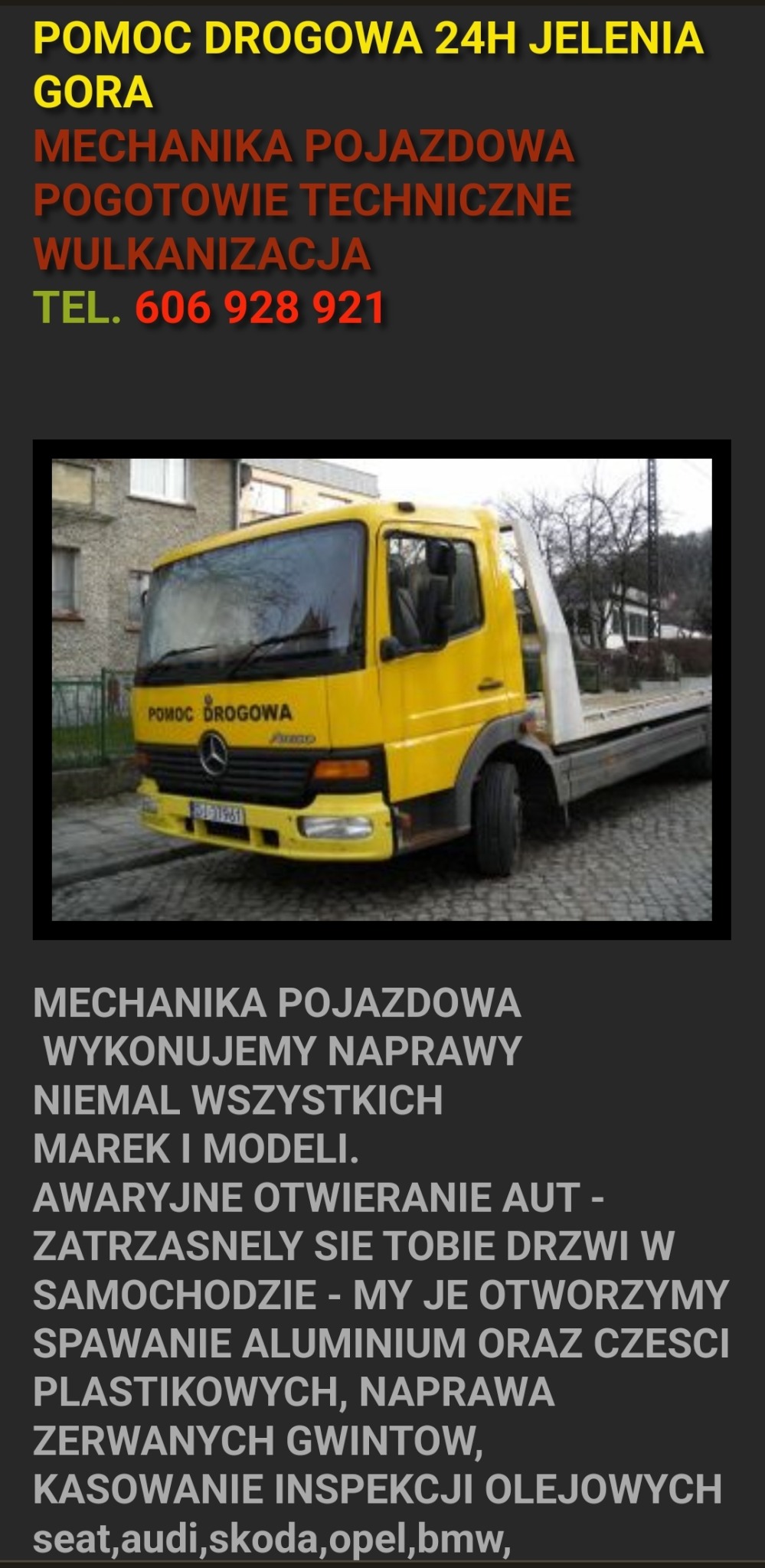 Żółty pojazd pomocy drogowej Mercedes-Benz z napisem 'Pomoc Drogowa' i numerem telefonu, zaparkowany na ulicy w mieście.