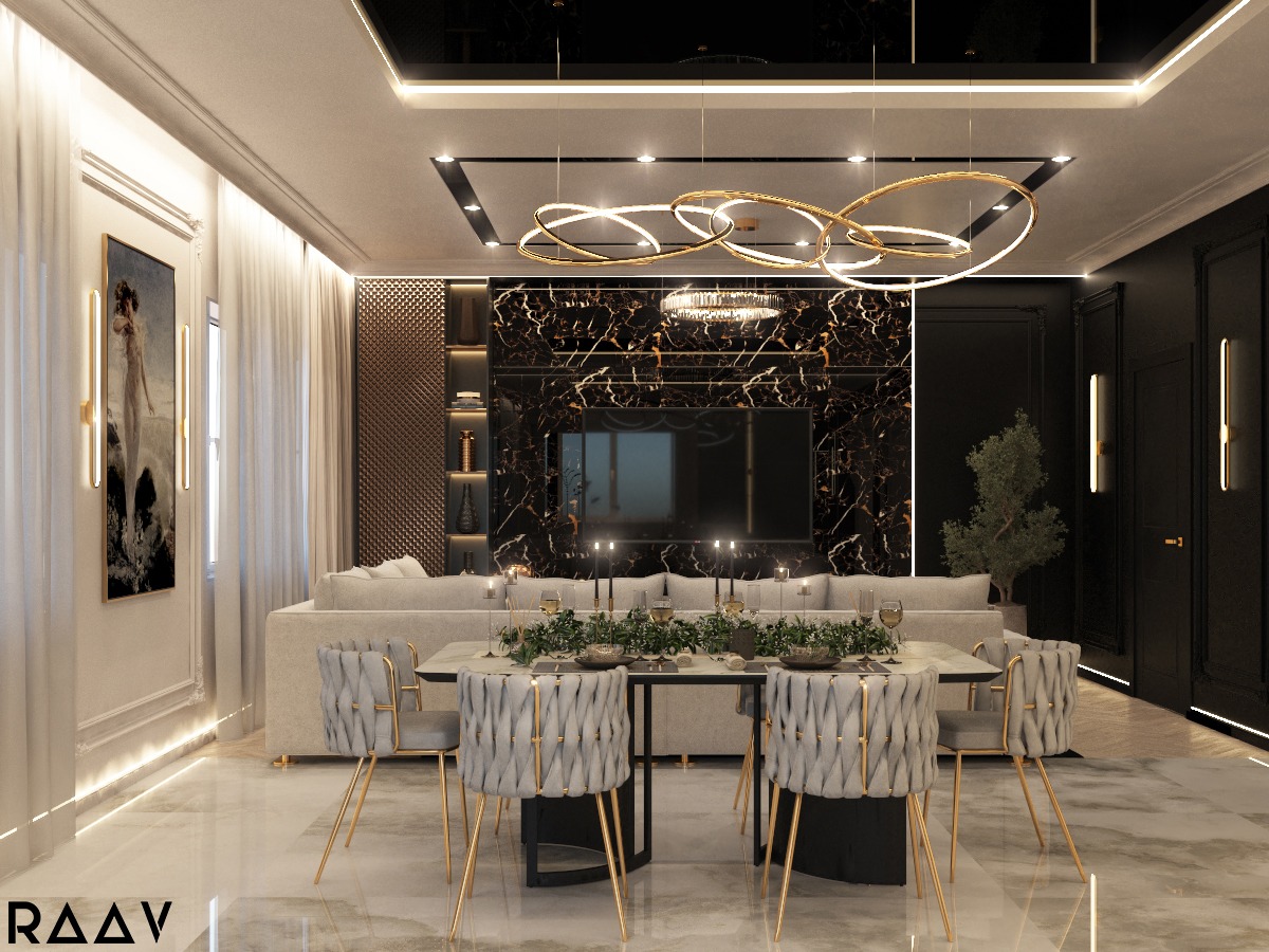 Eleganckie wnętrze: salon z jadalnią w stylu glamour, marmurowa ściana z telewizorem, nowoczesny żyrandol, stół z szarymi krzesłami i złotymi nogami, dekoracje roślinne, jasna sofa w tle.