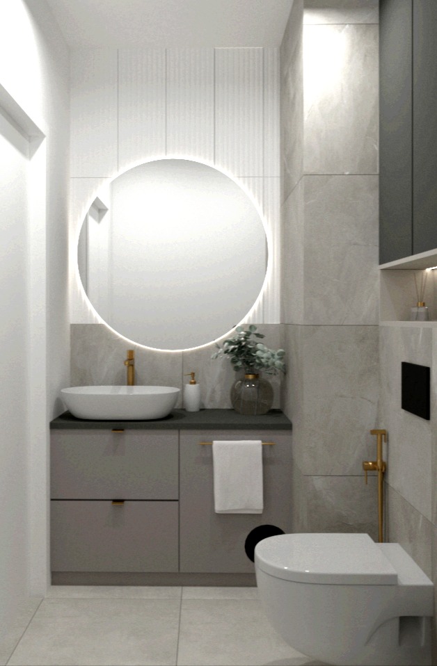 Nowoczesna łazienka z okrągłym lustrem podświetlanym LED, szarą szafką pod umywalką i marmurowymi płytkami ściennymi.