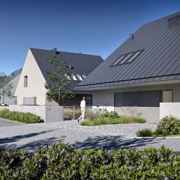 Kolorarchitektura - Wizualizacja szeregu nowoczesnych domów jednorodzinnych z ciemnymi dachami, jasnymi elewacjami, betonowymi ogrodzeniami i brukowaną drogą dojazdową, z osobą idącą w kierunku jednego z domów...