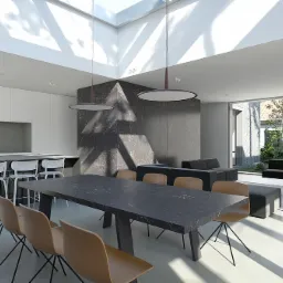 Jasne, przestronne wnętrze domu z nowoczesną kuchnią z wyspą, jadalnią z dużym stołem z blatem imitującym marmur i salonem z widokiem na ogród przez panoramiczne okno.