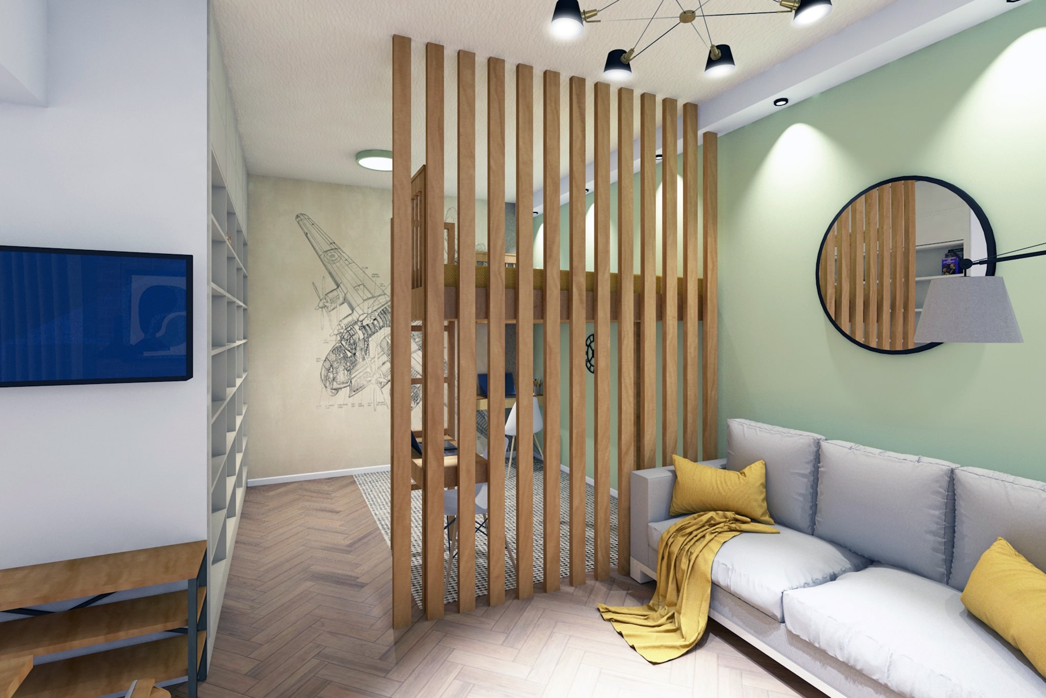 Wnętrze małego mieszkania z drewnianą ażurową ścianką działową oddzielającą strefę dzienną z szarą sofą i żółtymi poduszkami od strefy biurowej z biurkiem i krzesłami, na ścianie rysunek samolotu.