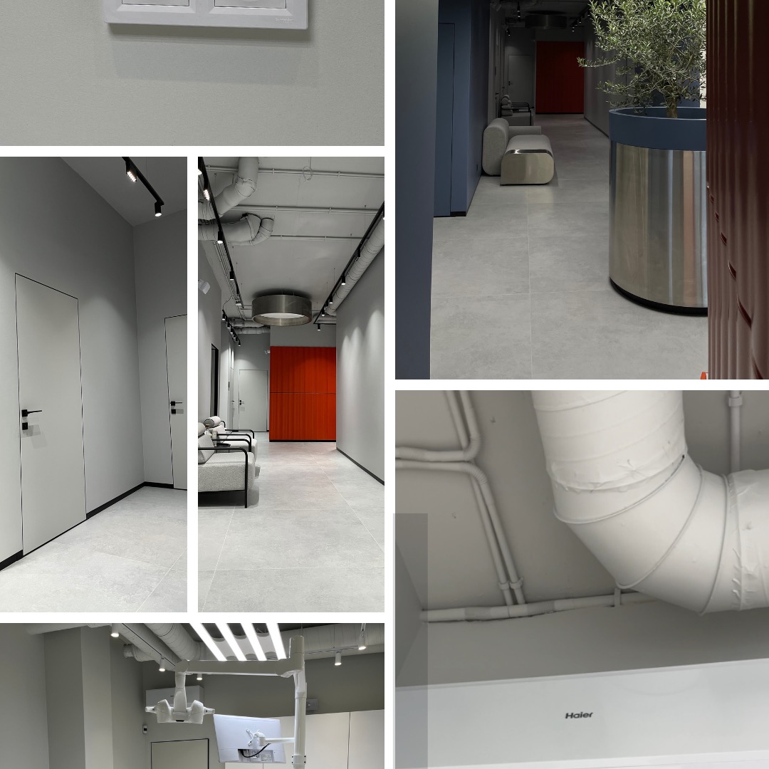 Nowoczesne wnętrze biurowe z minimalistycznym oświetleniem, szarą kolorystyką i elementami dekoracyjnymi, takimi jak donica z drzewkiem oliwnym i pomarańczowa ściana.