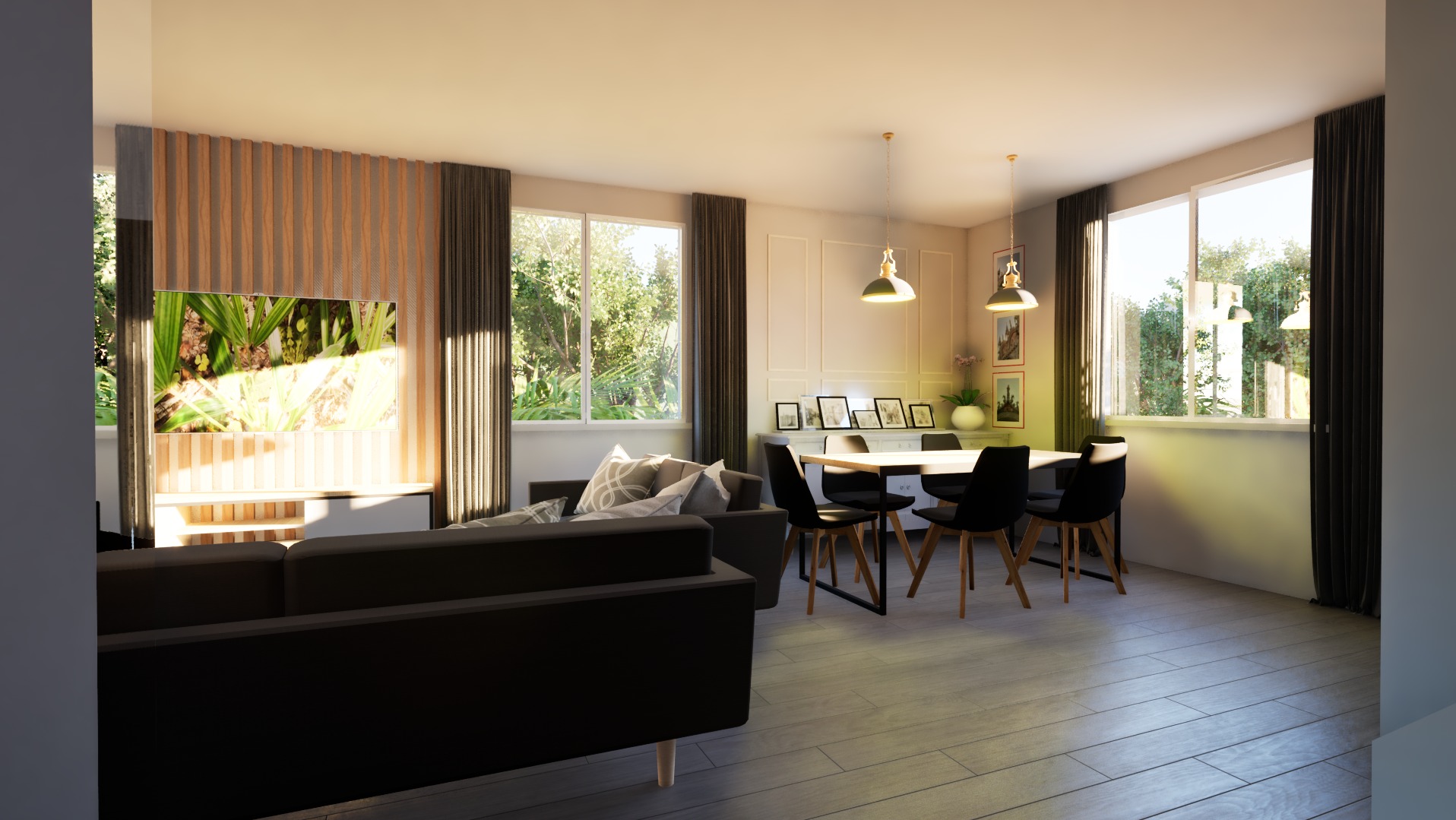 Jasne, przestronne wnętrze salonu z jadalnią, z ciemnoszarą sofą na pierwszym planie, drewnianym panelem za telewizorem i stołem jadalnianym z czarnymi krzesłami w tle.