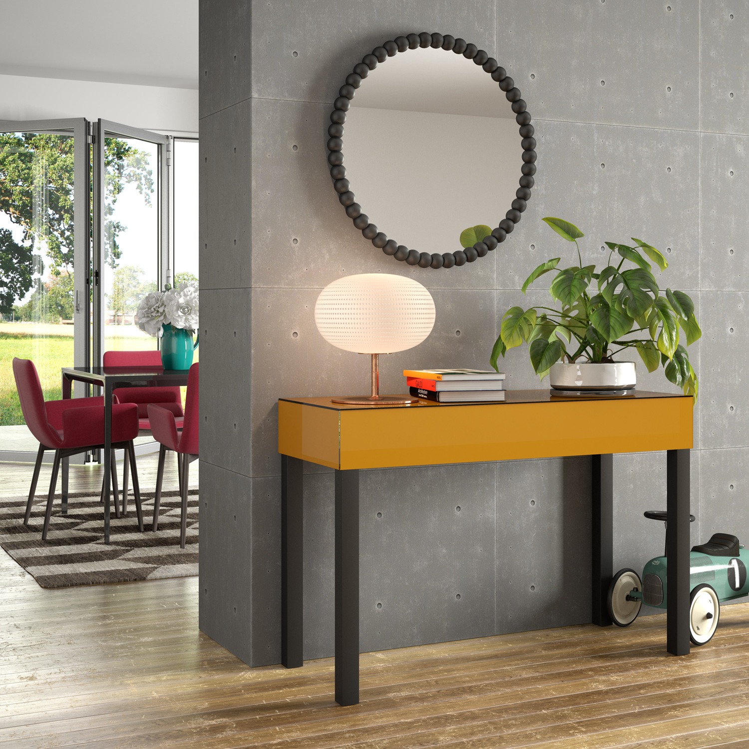 Nowoczesny przedpokój z konsolą w kolorze musztardowym, okrągłym lustrem z czarnymi kulkami i rośliną doniczkową, widok na jadalnię z czerwonymi krzesłami i wyjściem na ogród.