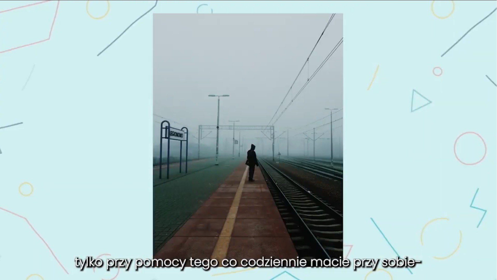 Sylwetka osoby stojącej na peronie w mglisty dzień, widoczny znak stacji Legionowo.