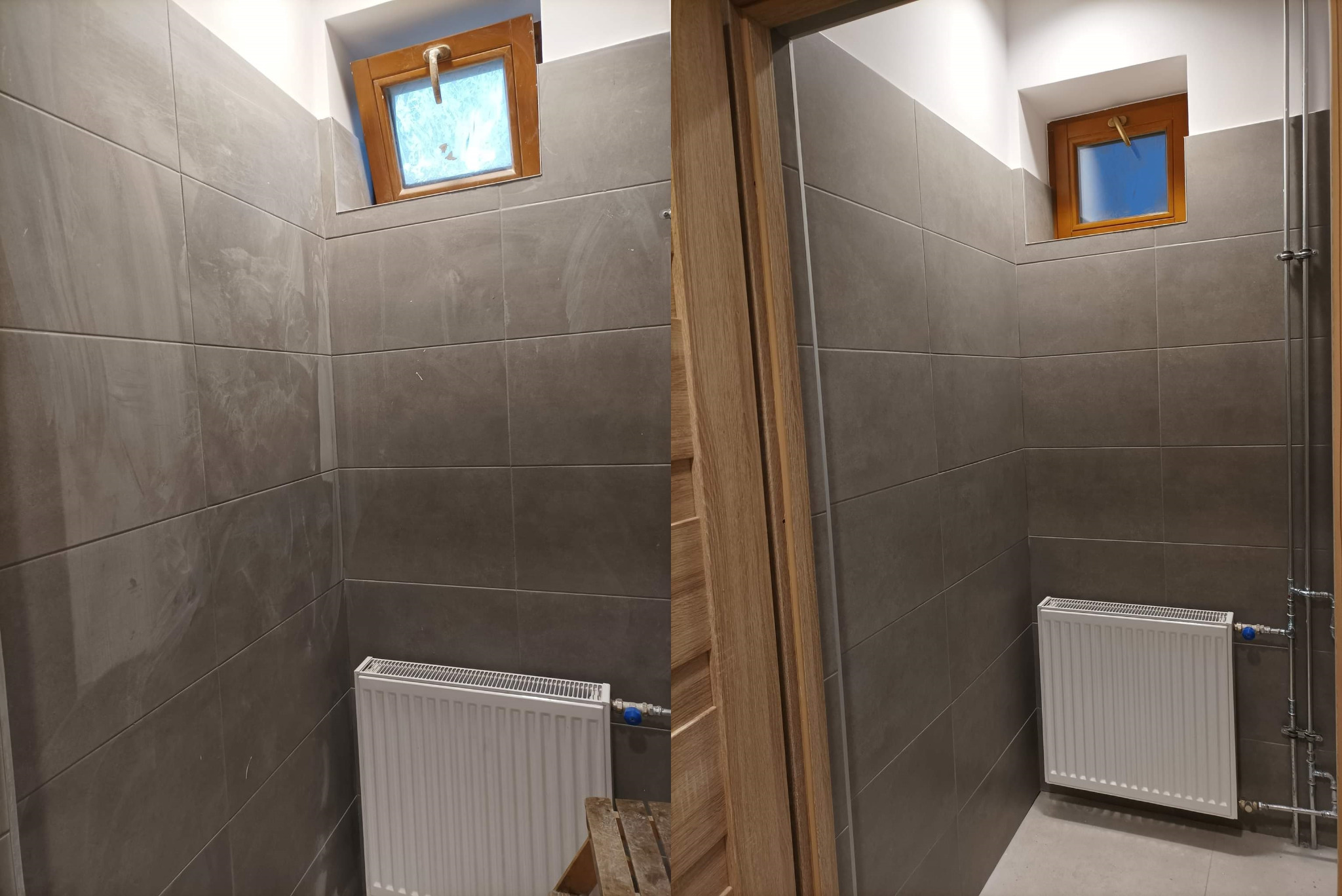 Szare płytki na ścianie w łazience z białym grzejnikiem, drewnianym oknem i częściowo widoczną drewnianą futryną drzwi.