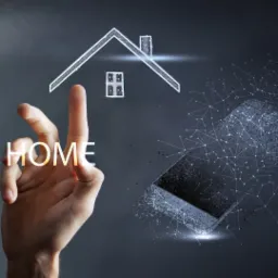 Stylizowana wizualizacja domu z interakcją dotykową, obok smartfon z efektem rozproszenia w formie sieci połączeń, napis HOME podświetlony na dłoni.