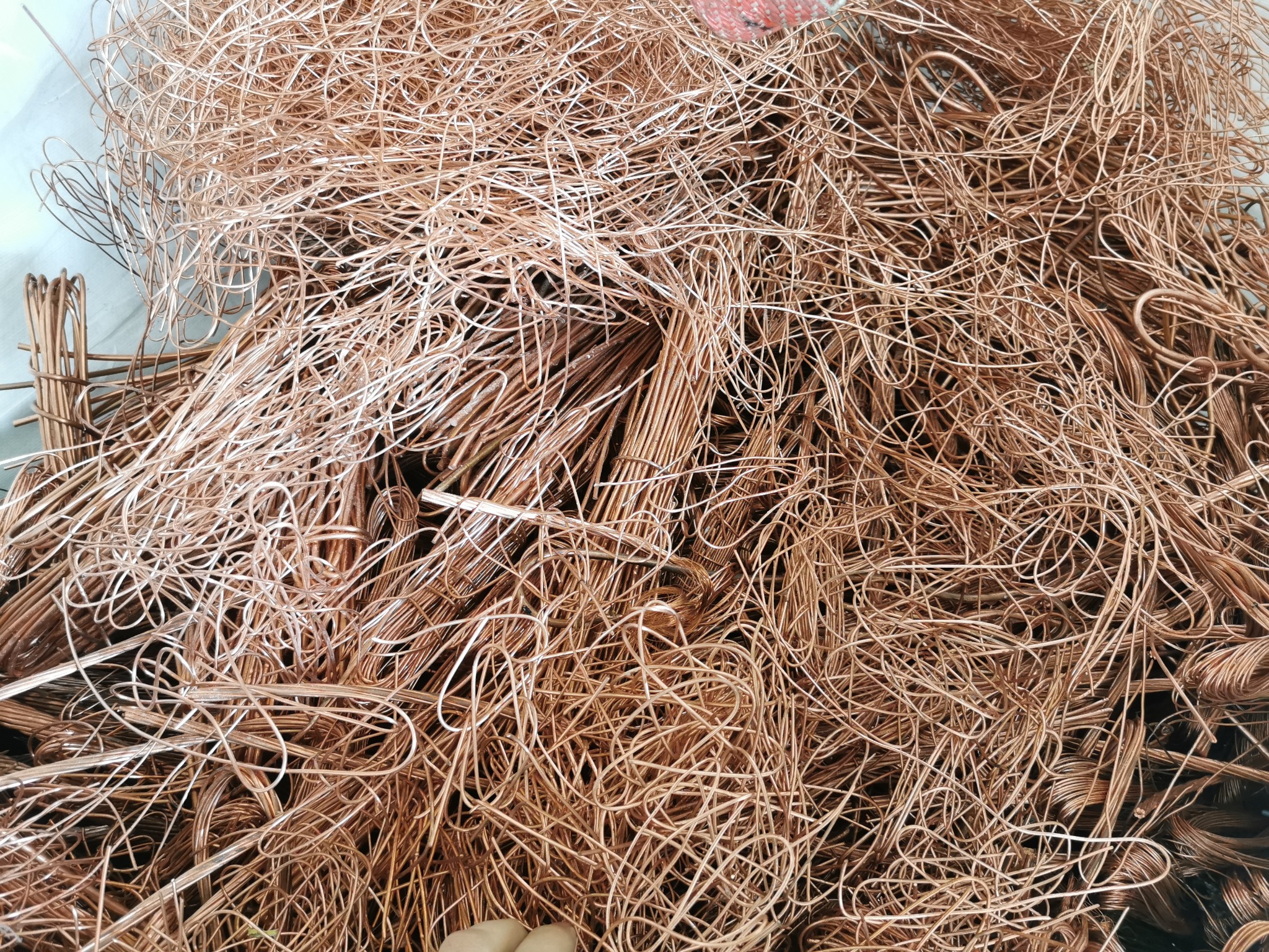 Stos miedzianych kabli i drutów przygotowanych do recyklingu, widoczne różnice w grubości i sposobie ułożenia