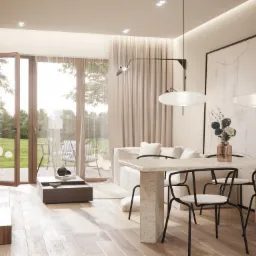 Jasne wnętrze domu z otwartą przestrzenią: stół z kamiennym blatem i krzesłami, sofa w tle, widok na ogród przez otwarte drzwi balkonowe, minimalistyczne oświetlenie i dekoracje.