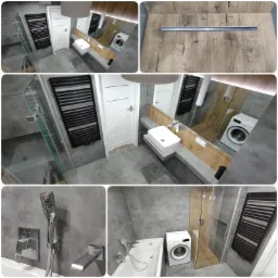 Nowoczesna łazienka w szarościach z drewnianymi akcentami: kabina prysznicowa ze szklanymi drzwiami, umywalka nablatowa na betonowym blacie, grzejnik drabinkowy w kolorze czarnym, pralka...