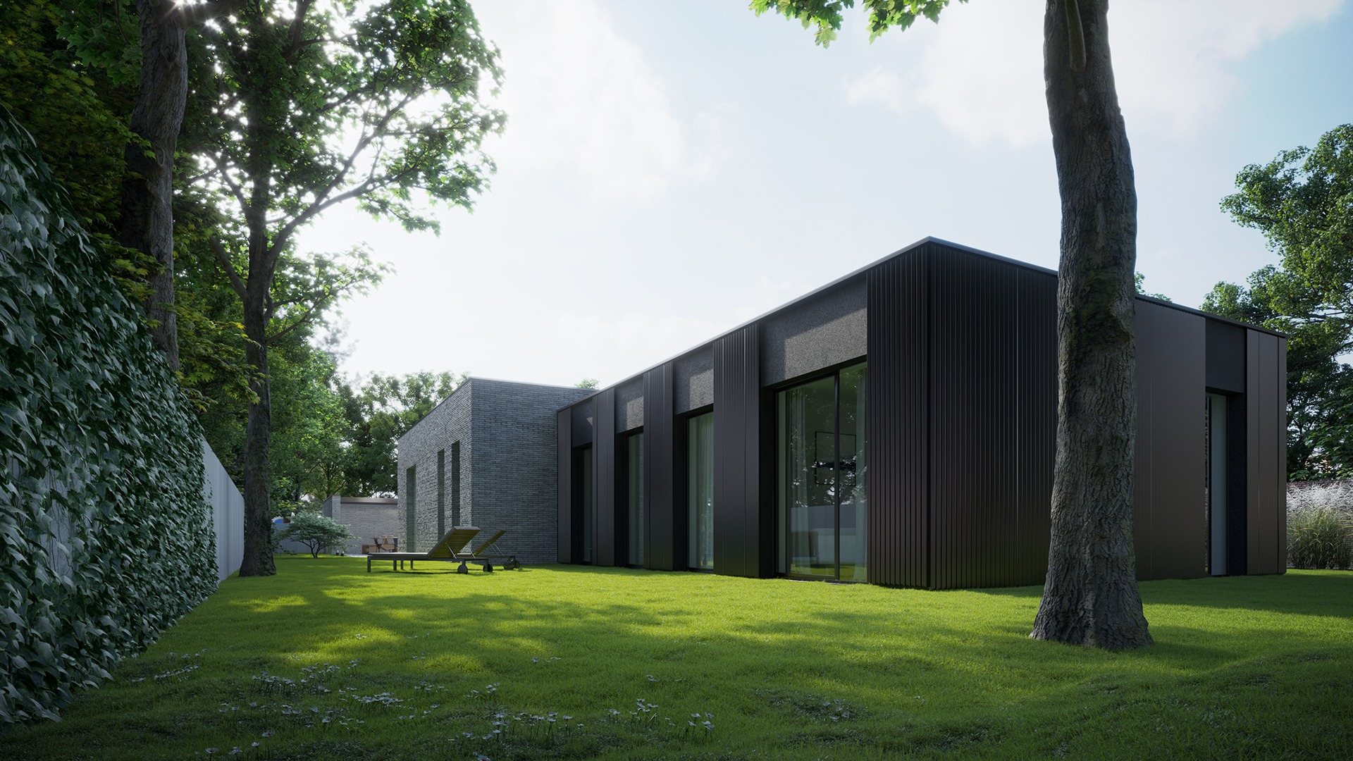 Nowoczesny dom jednorodzinny z ciemną elewacją i dużymi oknami, otoczony zielonym trawnikiem i drzewami, widok z perspektywy trawnika, na którym stoją dwa leżaki.