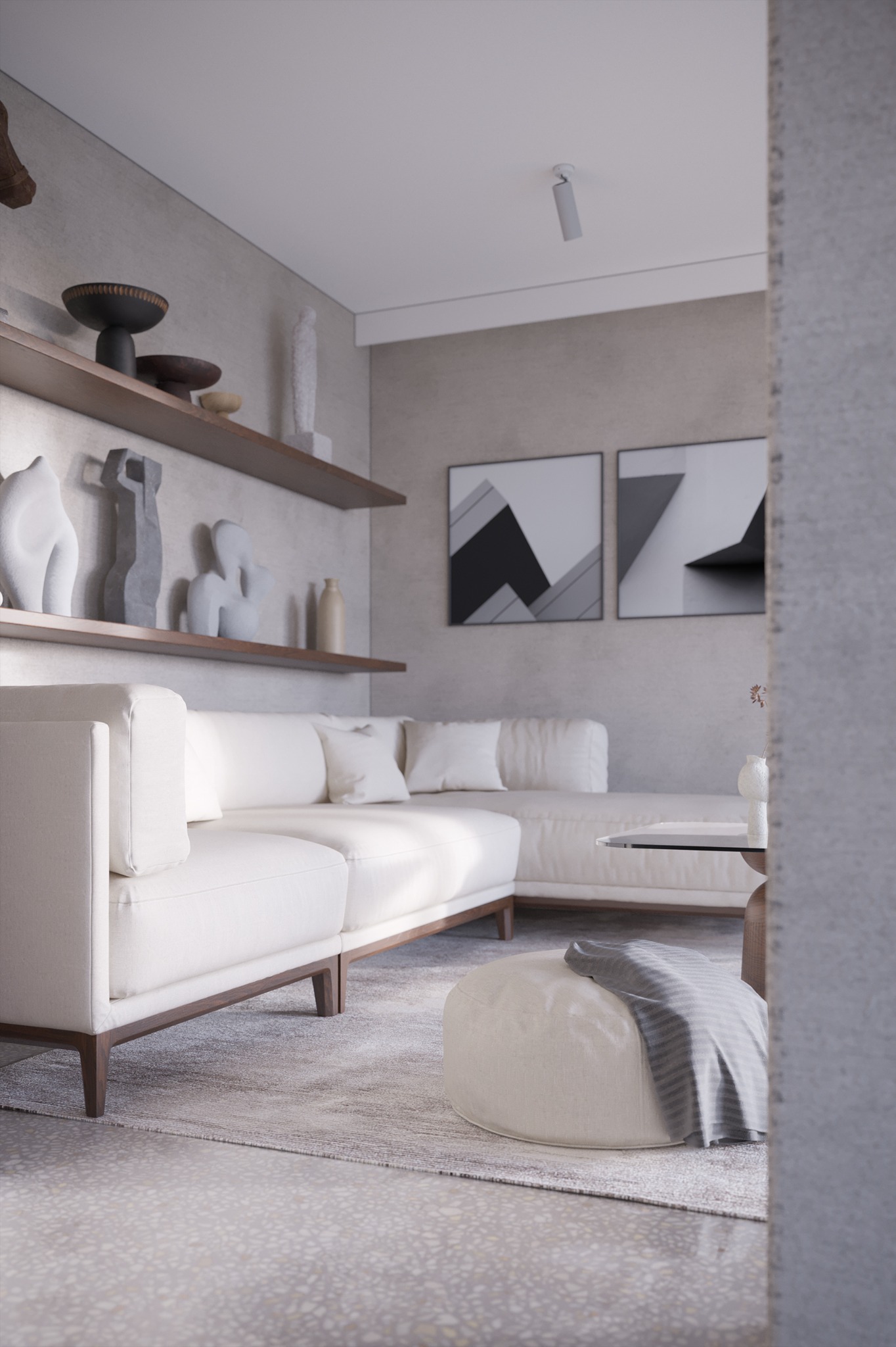 Jasne, minimalistyczne wnętrze salonu z białym narożnikiem, pufą z szarą narzutą i półkami z dekoracyjnymi rzeźbami, doświetlone punktowym światłem.