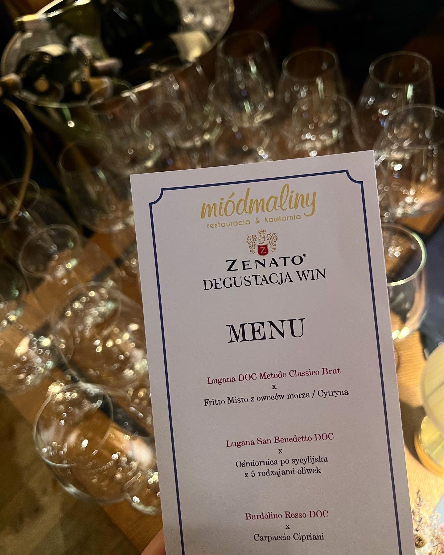 Menu degustacyjne win Zenato w restauracji Miódmaliny, z listą dań takich jak Fritto Misto i Carpaccio Cipriani, na tle kieliszków