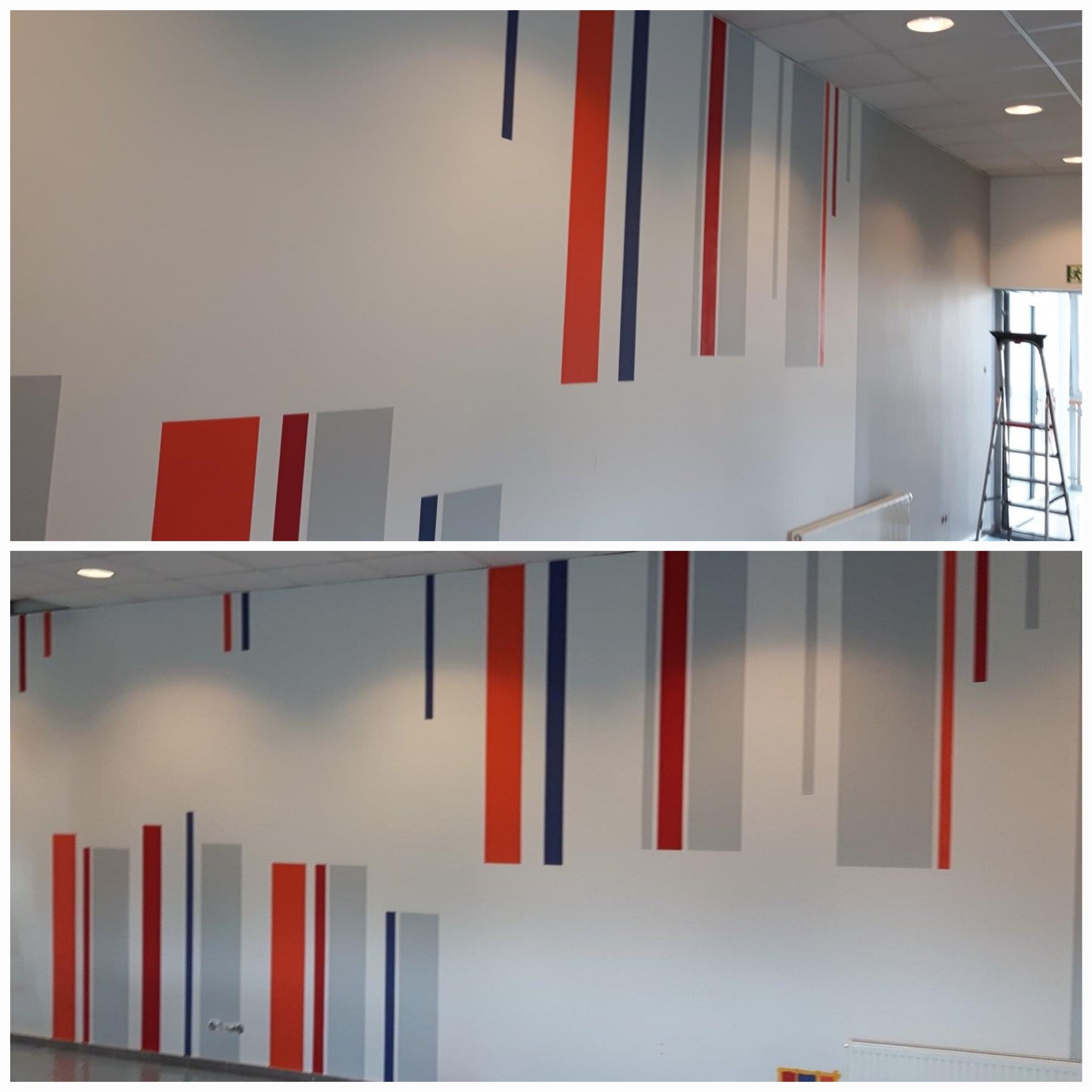 Ściana w korytarzu biurowym z abstrakcyjnym malowaniem w postaci pionowych pasów w kolorach czerwonym, szarym i granatowym, pasy częściowo sięgają sufitu, a w tle widoczna drabina przy drzwiach.