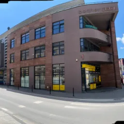 Budynek biurowy z szyldem 'Kancelaria Adwokacka' w Kielcach, widoczny z poziomu ulicy w słoneczny dzień.