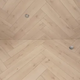 Jasna podłoga ułożona w jodełkę z widocznymi otworami po instalacji elektrycznej.