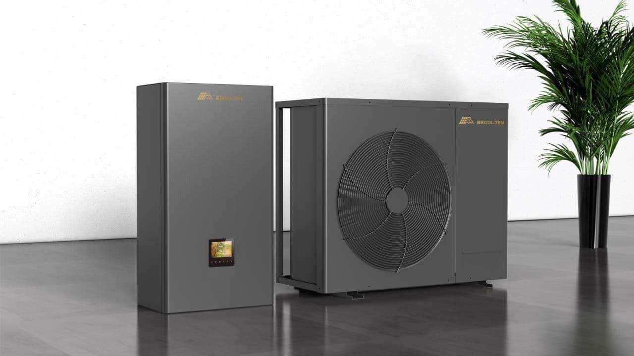 Szara pompa ciepła z jednostką wewnętrzną i zewnętrzną, widoczny ekran dotykowy na jednostce wewnętrznej i roślina doniczkowa w tle.