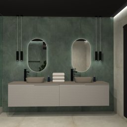 Flare Design Agata Mucha - Wizualizacja łazienki z zieloną ścianą, owalnymi lustrami podświetlanymi LED, beżową szafką z umywalkami i czarnym grzejnikiem. Minimalistyczny design.