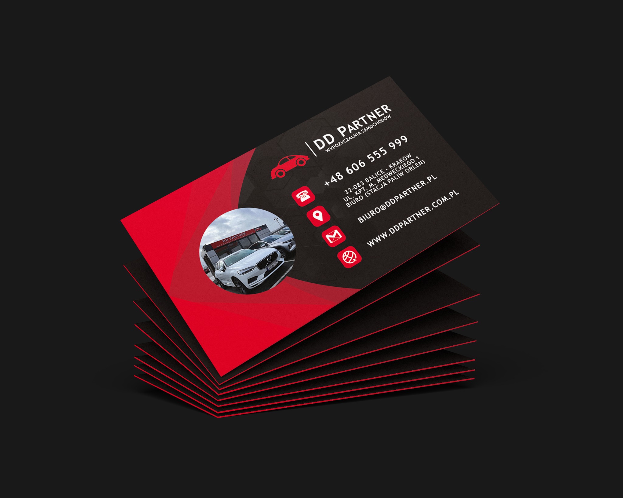 Stos wizytówek firmy wypożyczającej samochody, z logo DD Partner, adresem w Krakowie i danymi kontaktowymi, na czarnym tle.