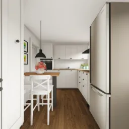 Wnętrze kuchni w stylu skandynawskim z drewnianą podłogą, białymi szafkami i blatem, oraz stalową lodówką, widziane z perspektywy otwartych drzwi.