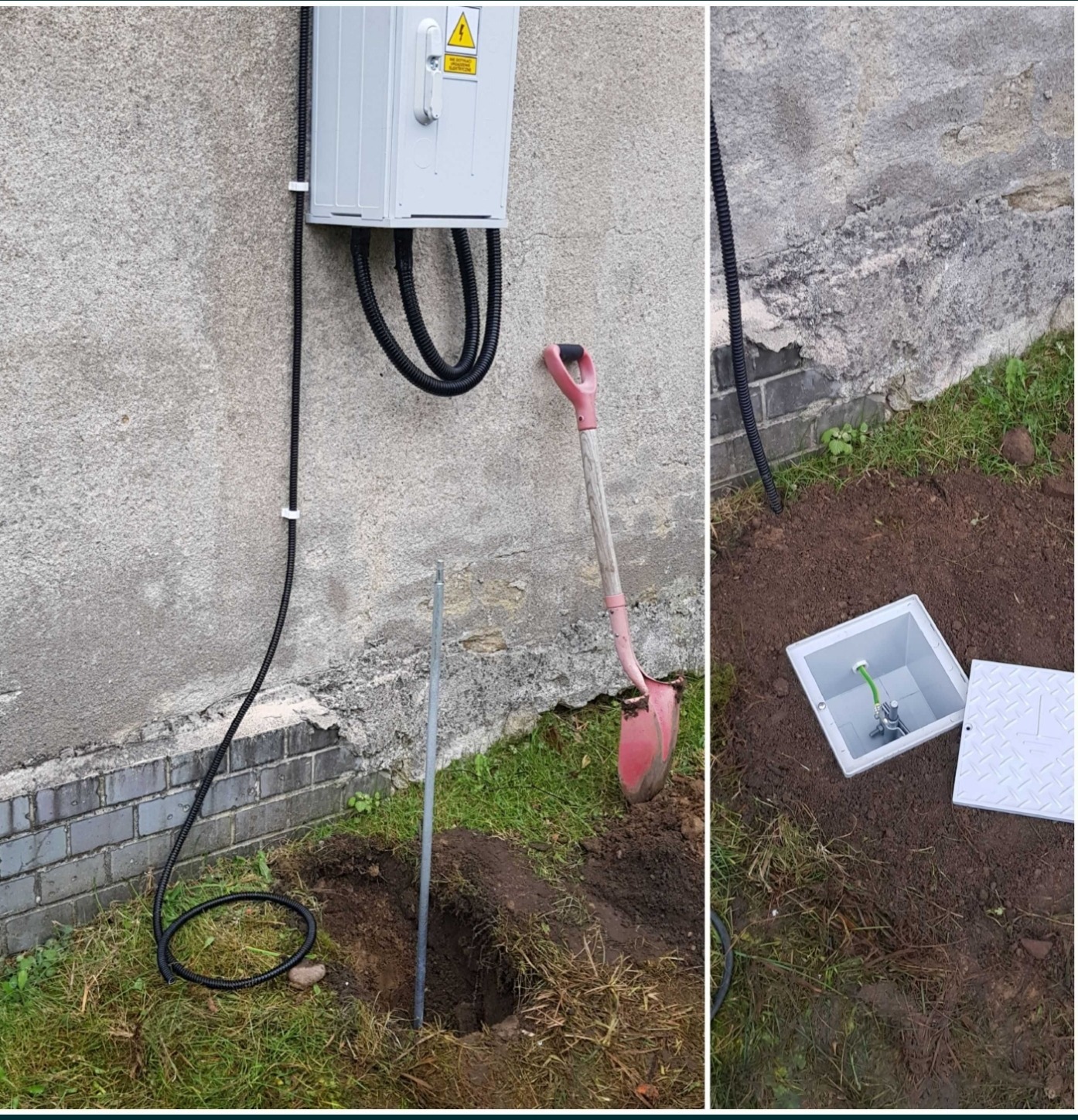 Zewnętrzna skrzynka elektryczna na szarej ścianie budynku, z ziemi wychodzą czarne kable w peszlu, obok wbita szpilka uziemiająca, a w pobliżu leży różowa łopata. W tle widoczny otwarty właz...