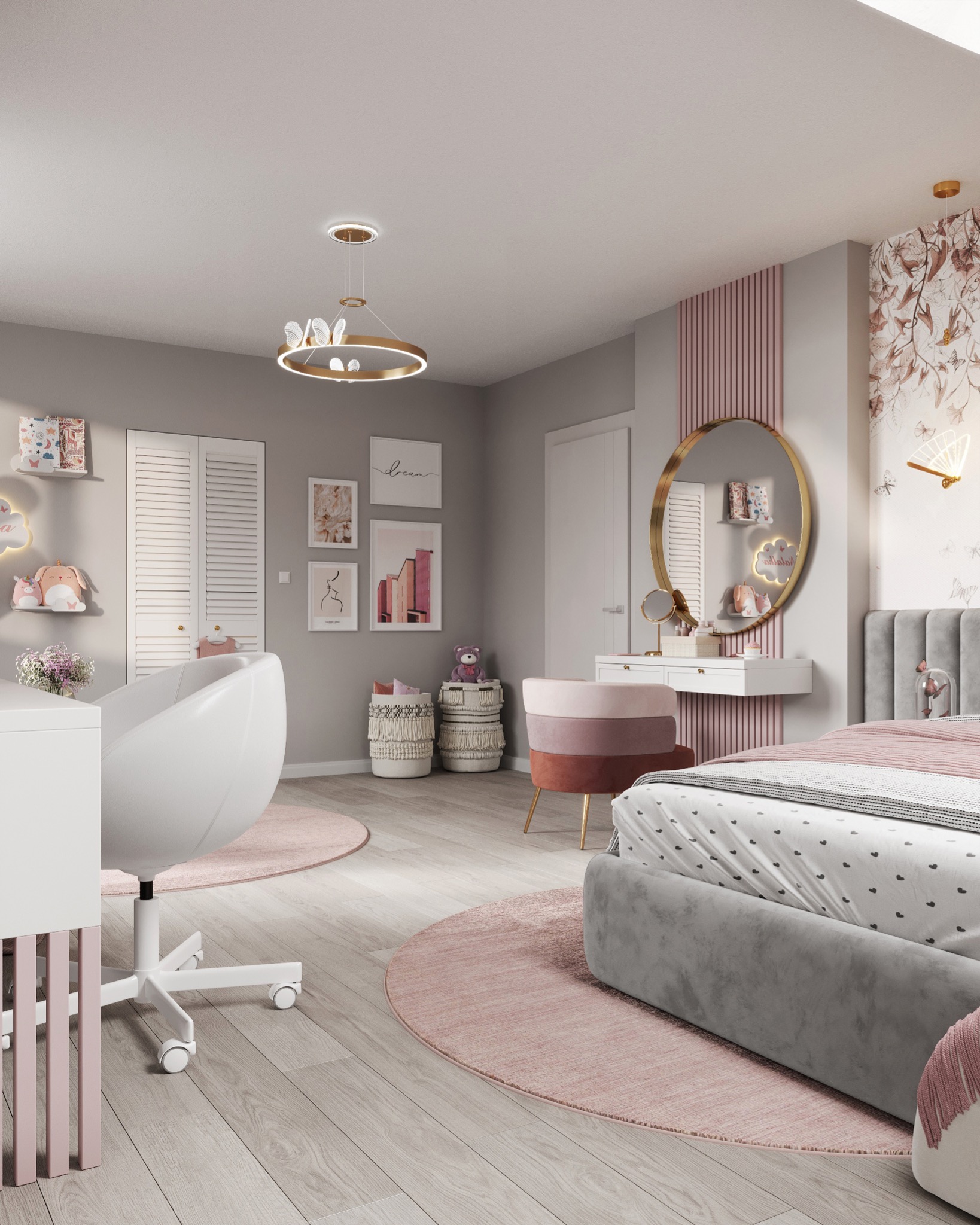 Jasna sypialnia dla dziecka z szarymi ścianami, łóżkiem z szarym wezgłowiem, toaletką z okrągłym lustrem w złotej ramie, biurkiem z białym krzesłem obrotowym, okrągłymi dywanami w odcieniach różu...