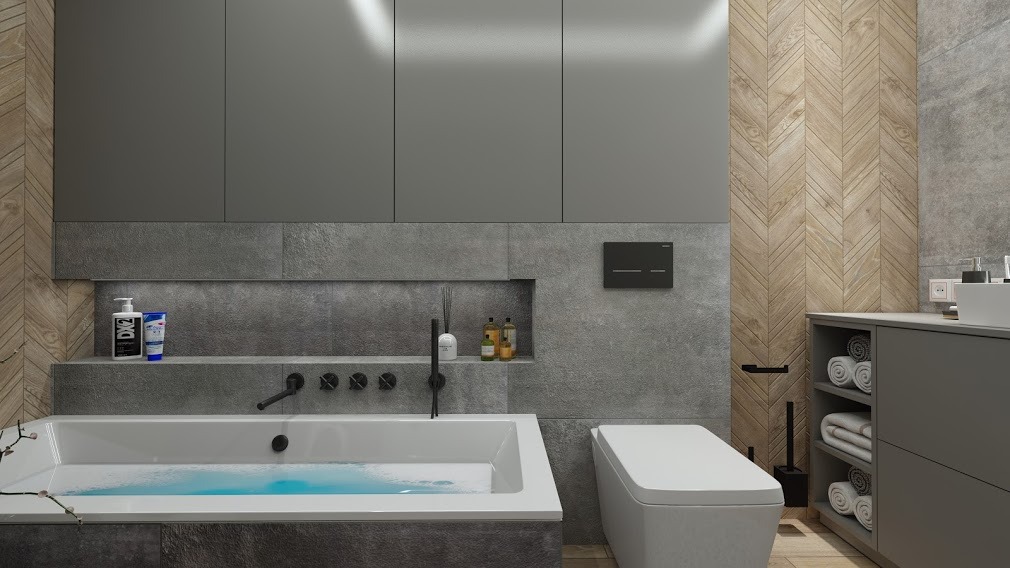 Nowoczesna łazienka z wanną wypełnioną wodą, szarą zabudową meblową, drewnopodobnymi płytkami ułożonymi w jodełkę na ścianie oraz minimalistyczną armaturą w kolorze czarnym.