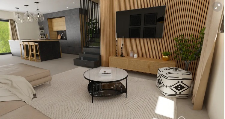 Wizualizacja nowoczesnego salonu z otwartą kuchnią, drewnianą ścianą z telewizorem, okrągłym stolikiem kawowym z marmurowym blatem i wzorzystym pufem.