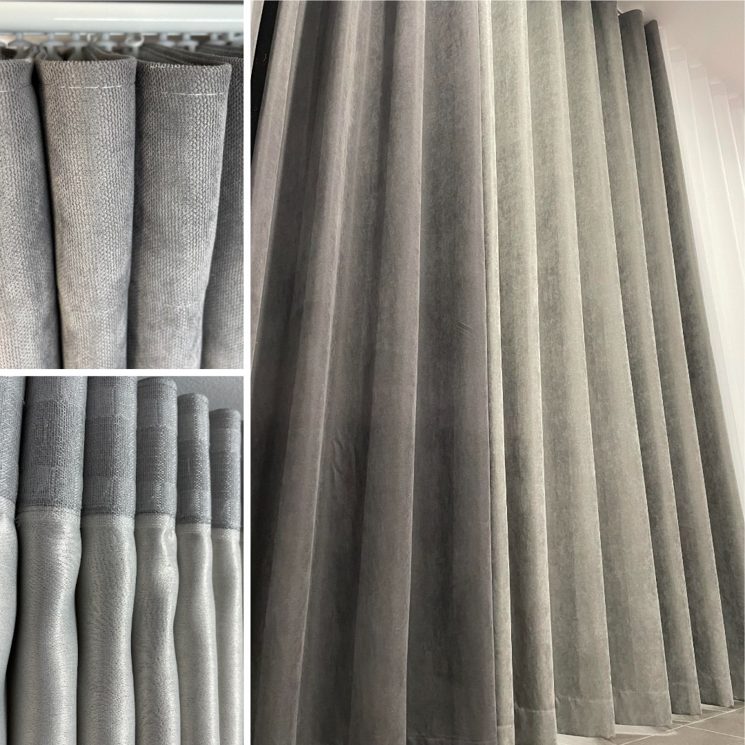 Szare, plisowane zasłony z widocznym detalem mocowania i fakturą materiału, oświetlone naturalnym światłem.