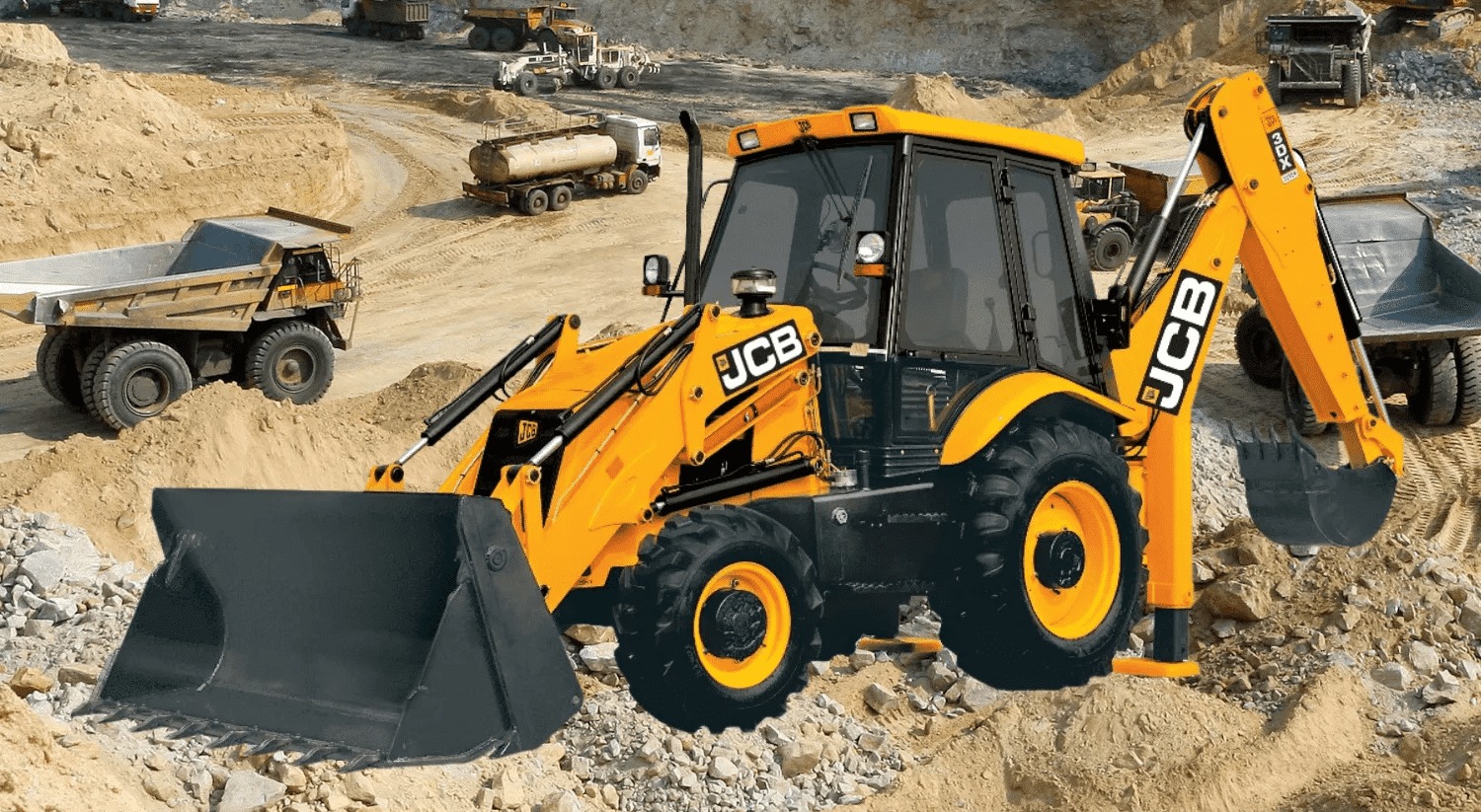 Żółto-czarna koparko-ładowarka JCB na placu budowy z piaskiem i innymi ciężarówkami w tle.