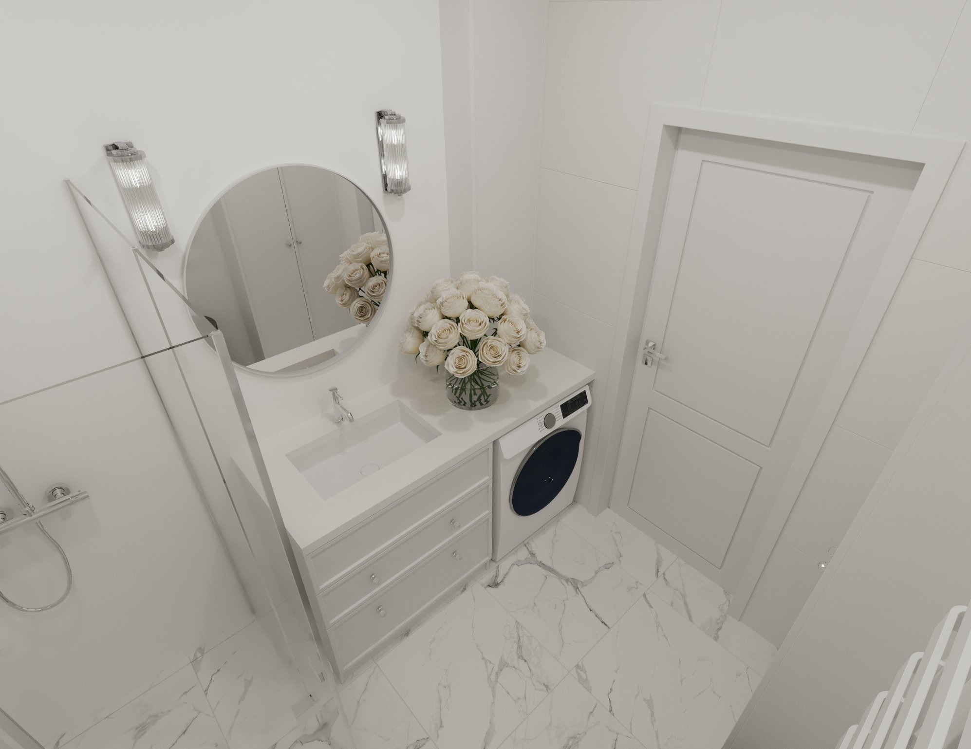 Biała łazienka z umywalką w zabudowie z szufladami, okrągłym lustrem, bukietem białych róż i pralką, wykończona w białych płytkach imitujących marmur.