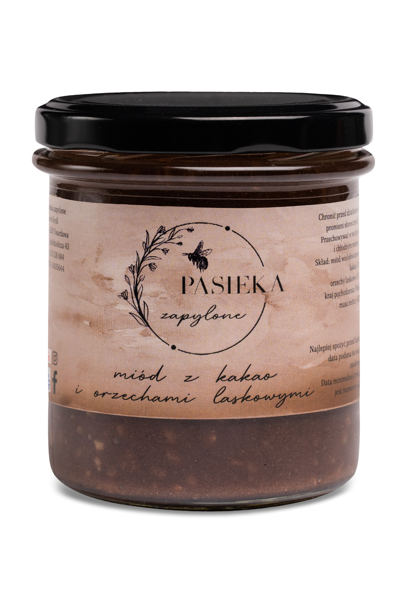 Słoik z miodem z dodatkiem kakao i orzechów laskowych, etykieta z napisem 'Pasieka zapylone', widoczne drobinki orzechów w miodzie.