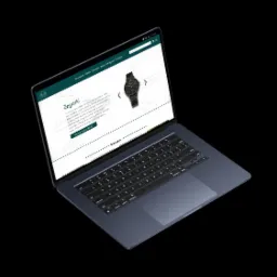 Laptop wyświetlający stronę internetową sklepu z zegarkami na czarnym tle, widok z góry pod kątem.