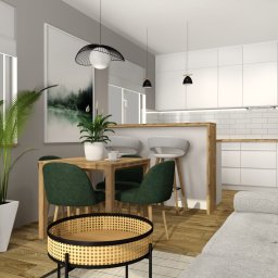 Darexpol - Wizualizacja nowoczesnego salonu z aneksem kuchennym, drewniany stół z zielonymi krzesłami, biała zabudowa kuchenna z płytkami metra, drewniana podłoga i elementy dekoracyjne z rattanu.