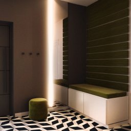 ASPEKT ARCHITEKTURA ANETTA SALA - Nowoczesny przedpokój z geometryczną podłogą, wbudowaną szafką z siedziskiem i pionowym oświetleniem LED, uzupełniony zielonym pufem.