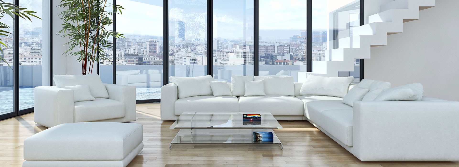 Jasne, przestronne wnętrze apartamentu z białymi meblami, szklanym stolikiem kawowym i widokiem na miasto przez panoramiczne okna.