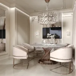 Elegancka jadalnia w jasnych barwach z okrągłym stołem z marmurowym blatem i złotą podstawą, otoczonym przez tapicerowane krzesła z metalowymi nogami. Nad stołem kryształowy żyrandol, a w tle...