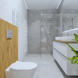 Nowoczesna łazienka z drewnianą zabudową toalety, szarą marmurową okładziną ścian i podłogi, kabiną prysznicową typu walk-in oraz białymi umywalkami na blacie z jasnego drewna, dopełniona zieloną...