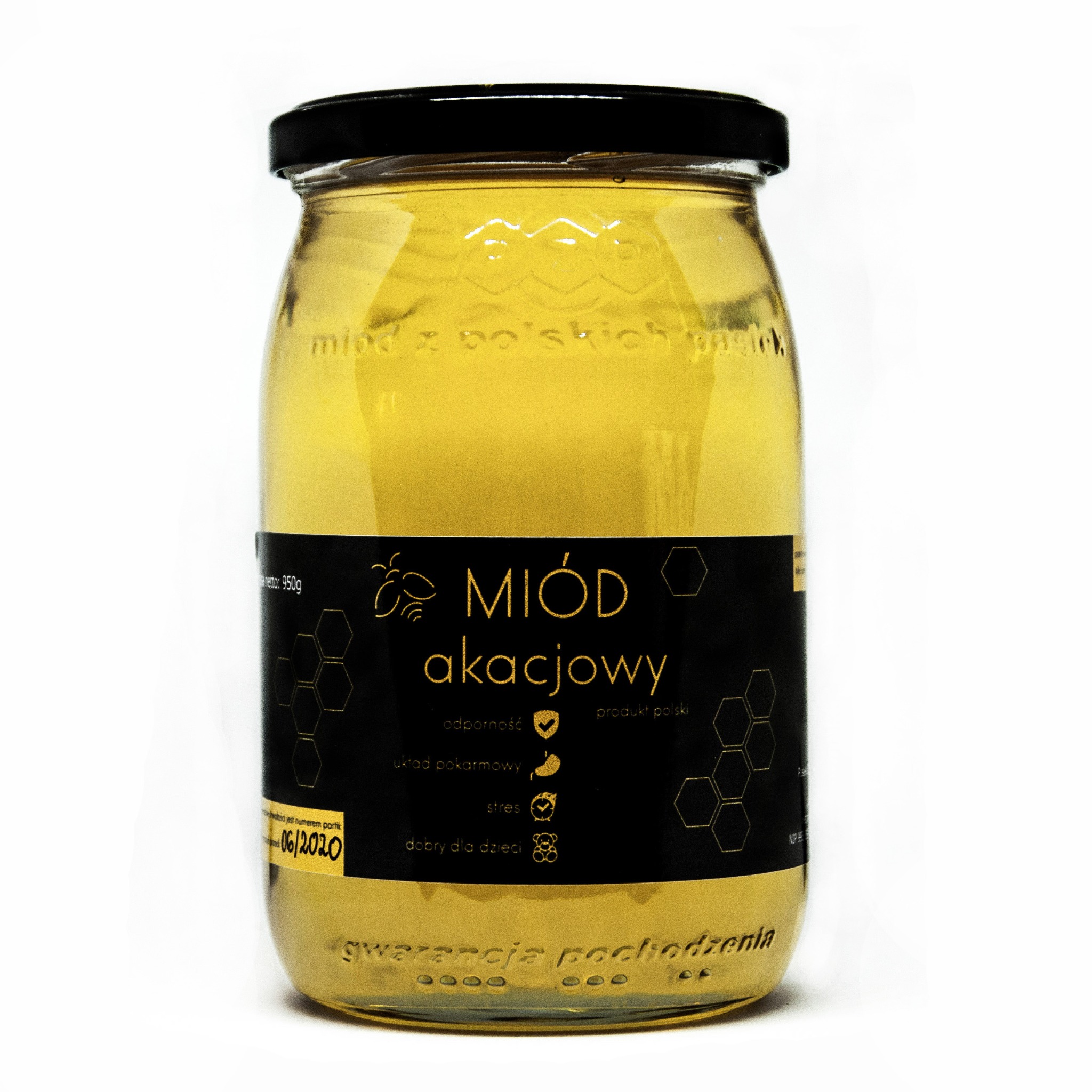 Słoik akacjowego, polskiego produktu z czarną etykietą, na której widnieją grafiki pszczół i plastrów miodu, a także informacje o właściwościach prozdrowotnych.