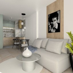 LK-Home Lidia Kowalczyk - Nowoczesny salon z drewnianą ścianą akcentującą, czarno-białym plakatem filmowym, szarą sofą z poduszkami, okrągłym stolikiem kawowym z białą dekoracją, rośliną w czarnej donicy oraz otwartą...