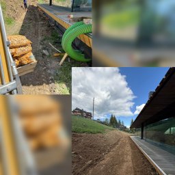 F.H.U.B. GĄSIENICA - Wykop pod nowoczesnym budynkiem z przeszkloną fasadą, widoczna ziemia, zielona rura drenażowa i worki z kruszywem. W tle górzysty krajobraz z domami.