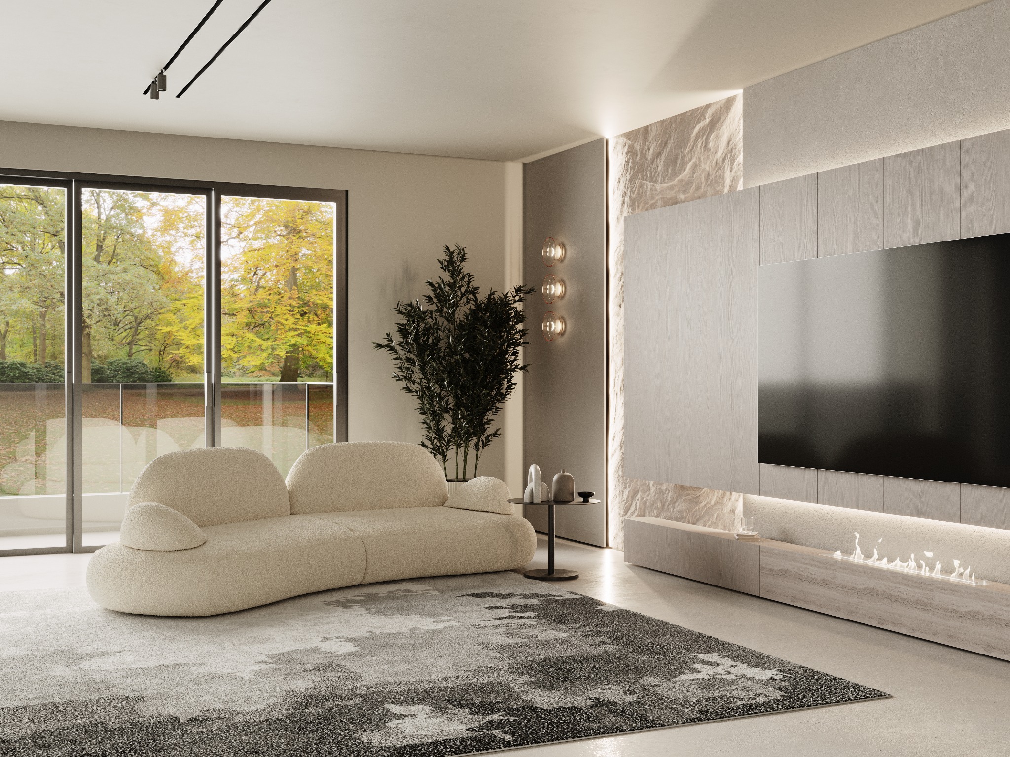 Nowoczesny salon z kremową, modułową sofą o zaokrąglonych kształtach, dywanem w odcieniach szarości i beżu, oraz ścianą z telewizorem i kominkiem elektrycznym. Za oknem widoczny jesienny krajobraz.