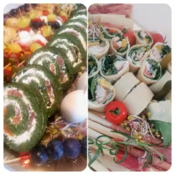 Dwa rodzaje roladki: szpinakowe z łososiem oraz z kurczakiem i warzywami, ułożone na srebrnej tacy z dodatkami: winogrona, jajka przepiórcze, pomidory, szparagi, szynka parmeńska, ogórki konserwowe...