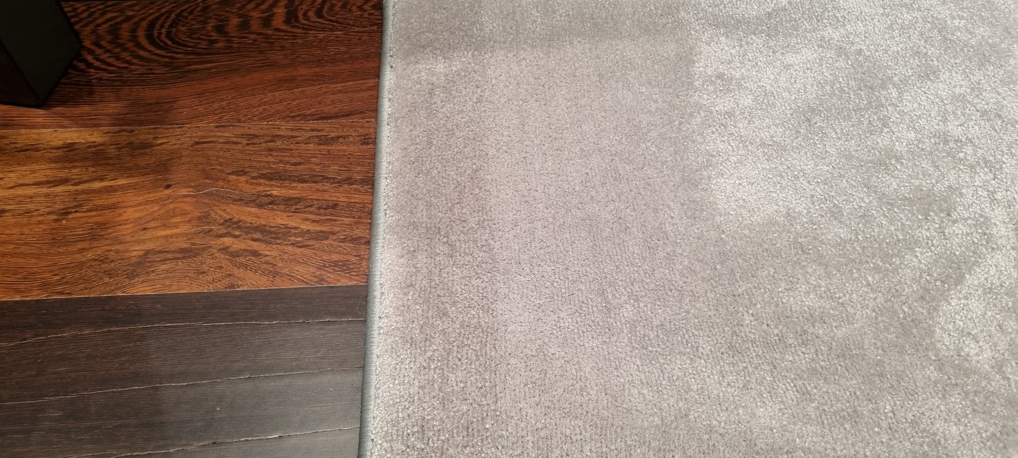 Wykładzina na podłodze drewnianej z obszyciem.