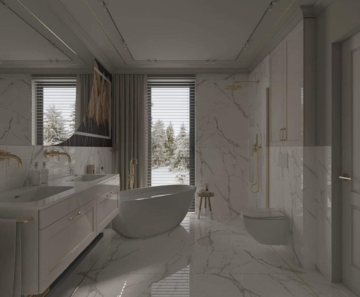 Elegancka łazienka z marmurowymi płytkami, wolnostojącą wanną, podwójną umywalką z szafką, złotą armaturą i widokiem na zimowy krajobraz za oknem.
