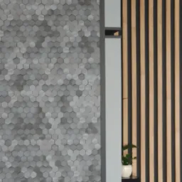 Fragment ściany wyłożonej szarymi, heksagonalnymi płytkami ceramicznymi, sąsiadujący z pionowymi panelami dekoracyjnymi z drewna i czerni, z elementami roślinnymi i sprzętem audio w tle.