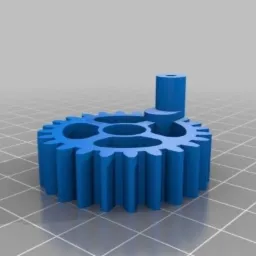 Niebieska, plastikowa zębatka z kołnierzem i otworem na os w górnej części, wydrukowana w technologii 3D, widoczna na tle siatki.